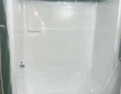 Refinished shower stall with a new smooth surface