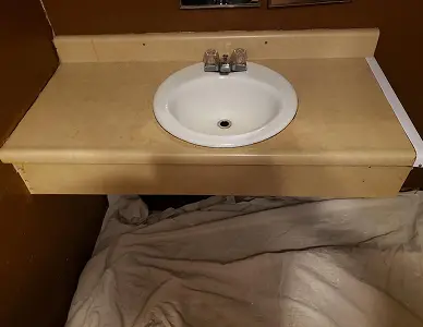 Damaged bathroom sink before restoration